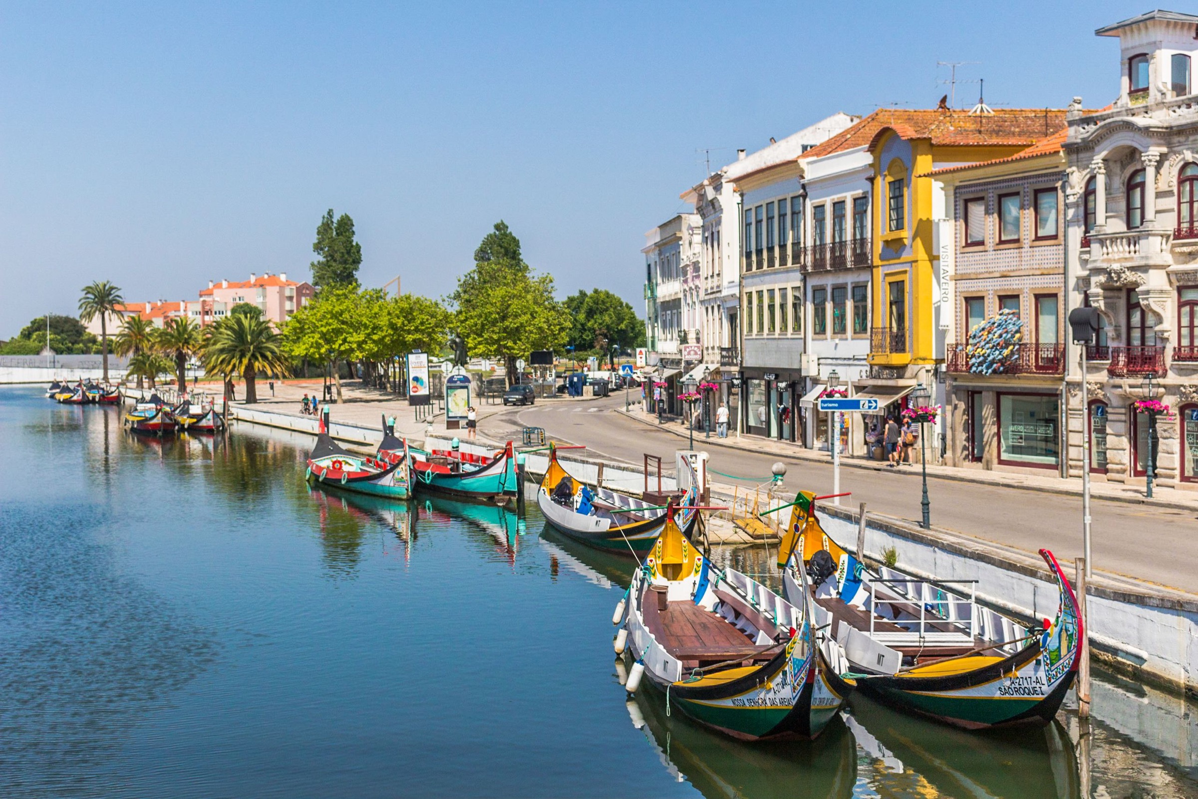 Traditional boats and colourful buildings beside a canal in Aveiro Portugal