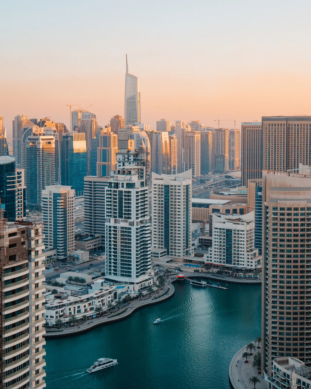 Dubai Marina buildings and boats at sunset