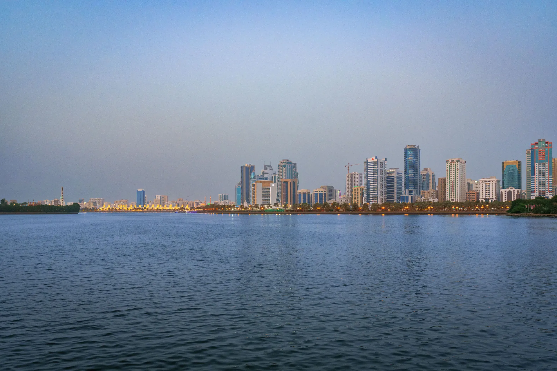 Sharjah skyline across the lagoon at dusk
